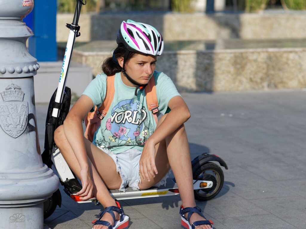 woman, e-scooter, helmet, sitting, outdoors, electric scooter, sidewalk, urban, city, resting, e-scooter, electric scooter, electric scooter, electric scooter, electric scooter, electric scooter